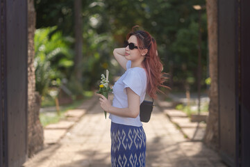 Pretty Asian tourists woman wearing beautiful hand-woven clothes dyed with indigo and mud-fermented...