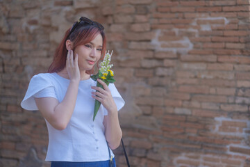 Pretty Asian tourists woman wearing beautiful hand-woven clothes dyed with indigo and mud-fermented...