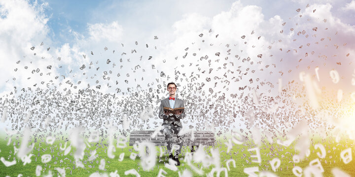 Young businessman or student studying the science and symbols fly around