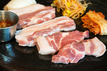 Fresh and delicious iron pan-fried black pork meal in Jeju Korean restaurant.
