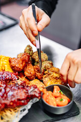 Chef cooking set of assorted grilled meat platter with differend chicken and vegetables salad on restaurant kitchen