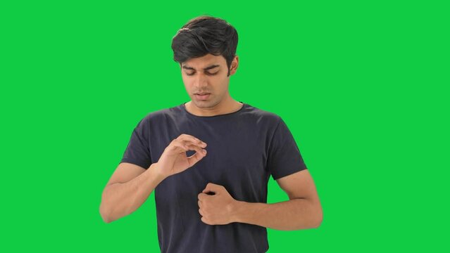 Indian boy having acidity and gastric problem Green screen