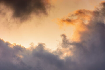 Fototapeta na wymiar evening sky in orange glow. huge fluffy clouds. dramatic natural background