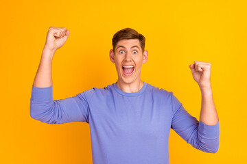 Man screaming winning lottery isolated on yellow color background