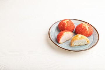 French custard dessert shu cake on white wooden, side view, copy space.