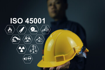iso 45001 is a workplace safety standard that deals with the health and safety of employees. Standard icons and safety symbols and staff holding helmet to encourage about safety matter - obrazy, fototapety, plakaty