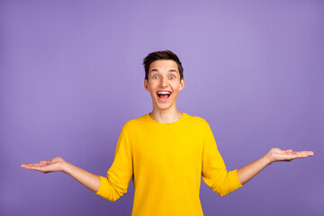 Photo of funny guy hold open palms hands advertising two products low prices advising isolated...