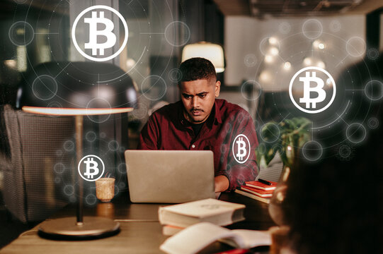 Crypto currency trader trading Bitcoin working on laptop