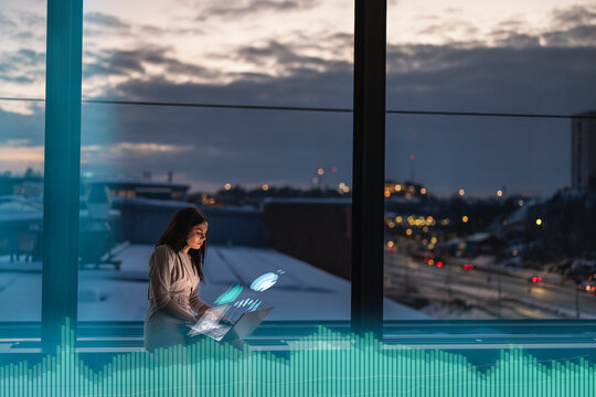 Female finance specialist working in office at night