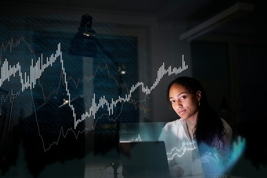 Female finance specialist working in office at night