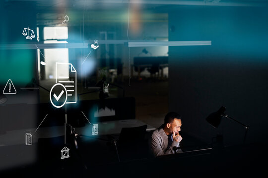 Male finance specialist working in office at night