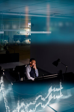 Male finance specialist working in office at night