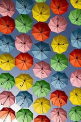 Fototapeta na wymiar bright multicolored umbrellas against the blue sky