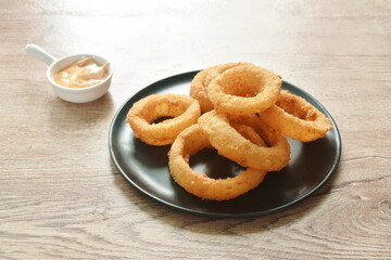 fried onion ring with flour dipping cheese and mayonnaise sauce on plate