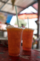Iced black tea in takeaway glass in Thai local restaurant