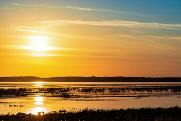 Fototapeta na wymiar Beautiful sunset by a lake