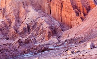 Close up of bare rocks in the barren desert landscape of the Moon valley (Valle de la Luna) in the vicinity of San Pedro de Atacama in the blue hour before sunrise