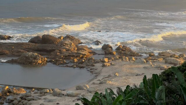 Wild beach with waves breaking on rocks, North Coast, Kwazulu Natal South Africa
