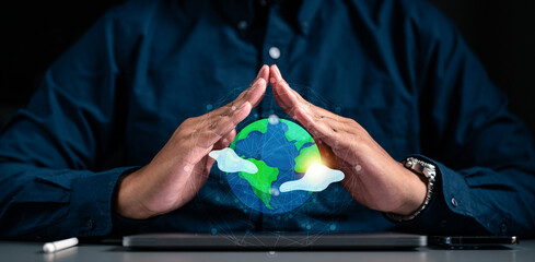 Earth under human hands, earth day, energy saving concept. Businessman holding glob in hand for...