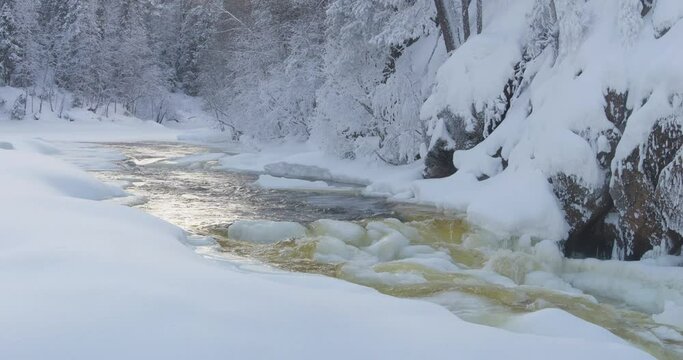 Winter in Finland; landscape with the half frozen Patoniva river in Oulanka National Park
