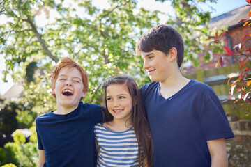 Obraz premium Family Shot With Loving Brothers And Sister In Garden At Home Together