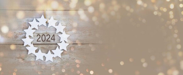 Christmas Winter and New Year 2024 background banner, header, panorama - Star wreath with beautiful bokeh lights - copy space - xmas card