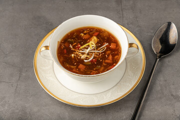 Hot and sour veggie soup on a white porcelain plate