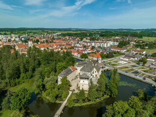 Aerial view of Blatna medieval water castle with towers,  turrets, plus extensive grounds in Bohemia