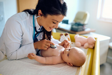 Baby girl being examined by female pediatrician at doctor's office.