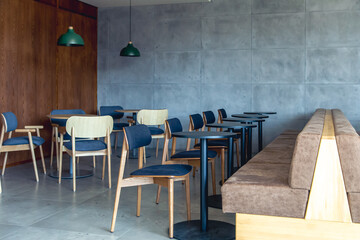 Interior of a modern cafe with sofas, chairs and tables.