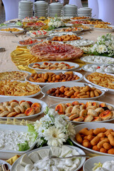 Table set with a large buffet. Catering with various kinds of food