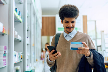 Young Muslim man buying medicine in pharmacy.