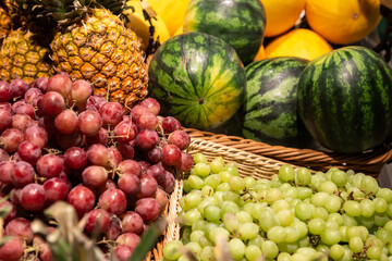 Baskets with exotic fruits on a supermarket showcase.