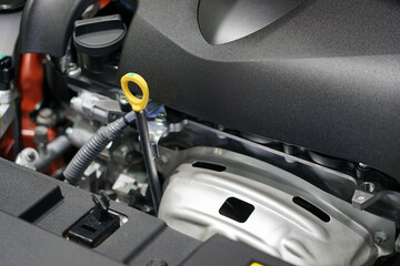 Oil level dipstick located inside the engine compartment of the car.