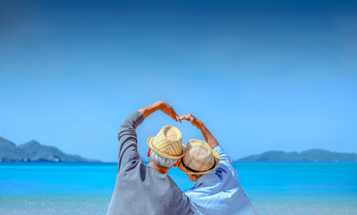 Plan life insurance of happy retirement concepts. Senior couple sitting and make a heart shaped...