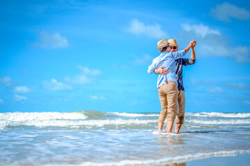 Plan life insurance of happy retirement concepts. Senior couple dancing at the beach looking the...