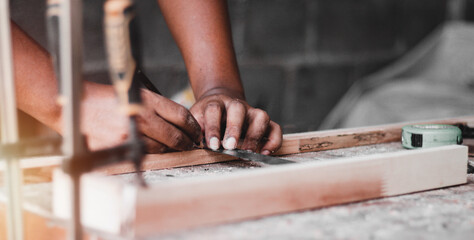 Carpenter working with equipment on wooden table, And measurement of a wooden plank