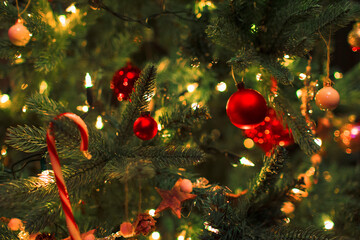 Close up ornaments and string lights on Christmas tree