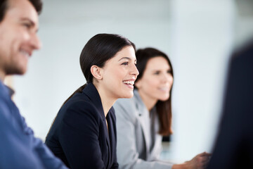Smiling businesswoman listening in meeting