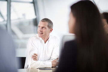 Businessman listening looking away in meeting