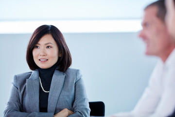 Smiling businesswoman listening in meeting