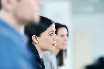 Attentive serious businesswoman listening in meeting