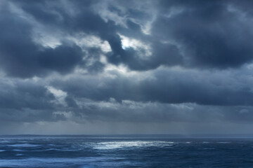 Dark clouds in overcast sky over ocean, Devon, United Kingdom