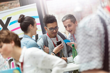 Business people using smart phone at technology conference