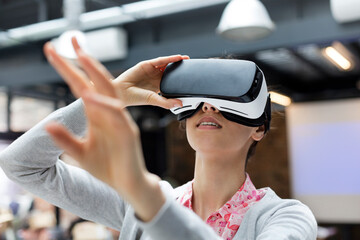 Woman trying virtual reality simulator glasses glasses reaching