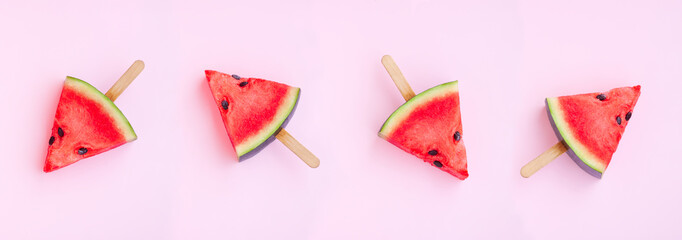 Watermelon fruit sliced with wood ice cream stick on pink background, Watermelon ice cream, watermelon popsicle, Summer concept