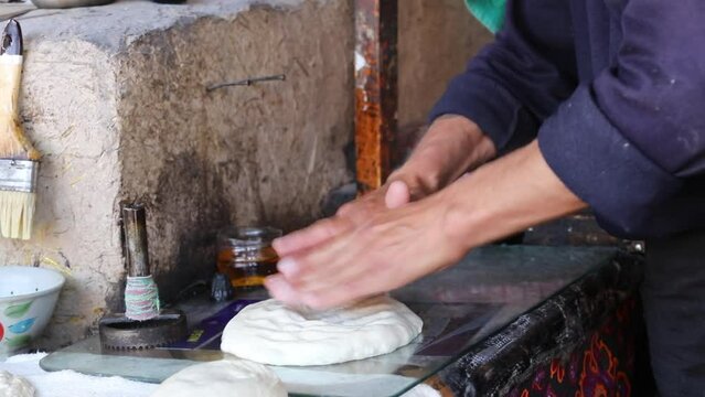  The baker forms the dough for Uzbek flatbread