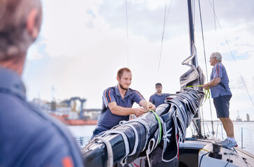 Men preparing sailing equipment