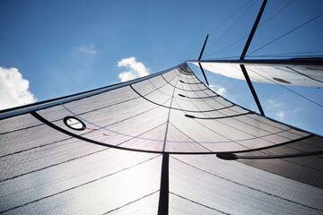 Sailboat sail against sunny sky