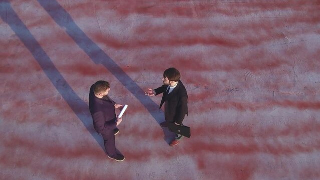 Two business men agree on business and shake hands and disperse. Copter flight